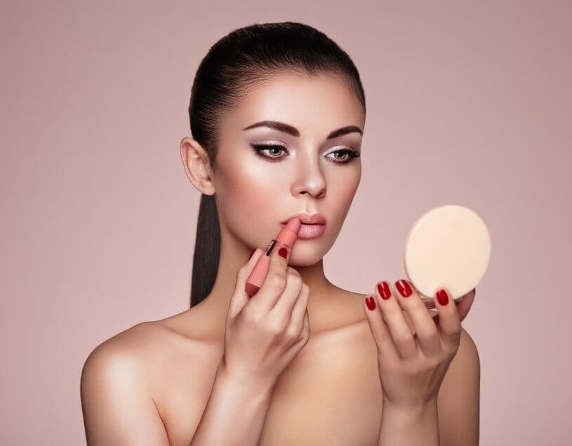 demo-attachment-1154-beautiful-woman-paints-lips-with-lipstick-PMB6YWP